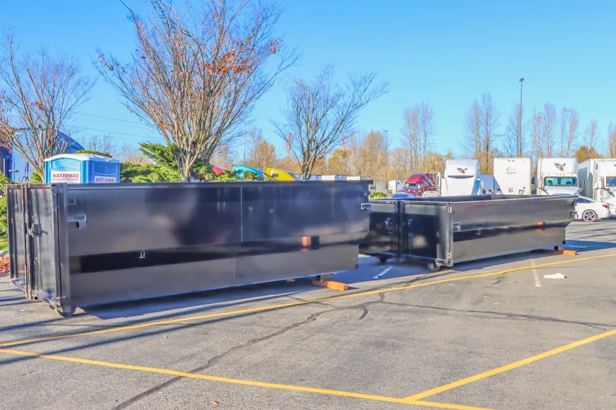 Professional dumpster rental service with roll-off container on residential driveway in Pahokee